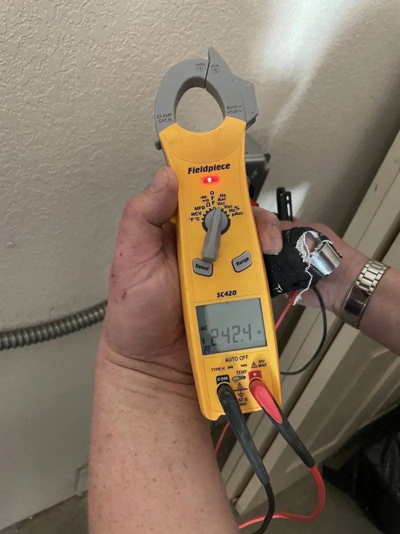 Voltage testing with clamp meter during Recessed Lighting Installation in Morton